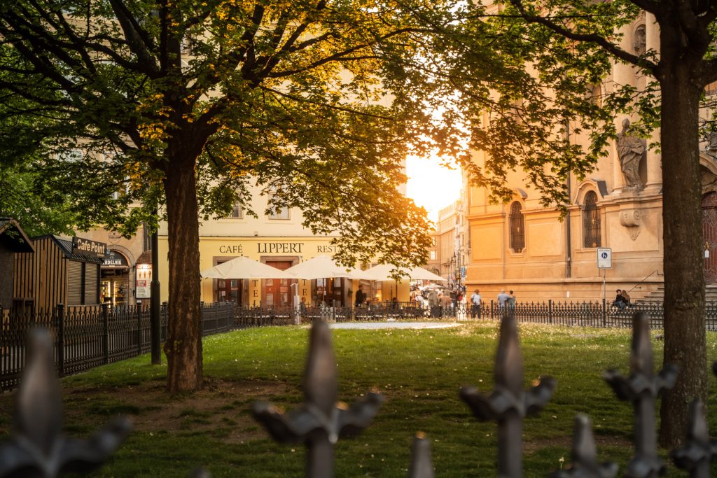 Gardens at the edge of the Old Town Square at sunset